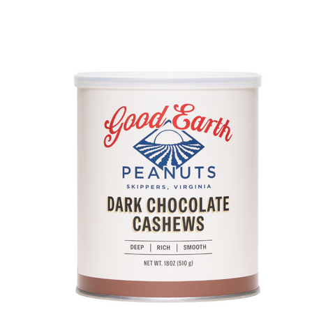 A white cylindrical canister of Good Earth Peanuts Dark Chocolate Cashews, featuring a white lid and a label with red and blue branding, set against a plain white background.